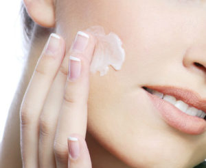 applying moisturizer on face